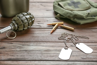 Set of military outfit on wooden background