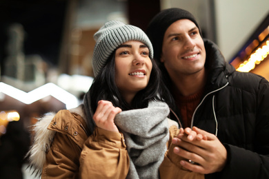 Photo of Lovely couple on city street. Winter vacation