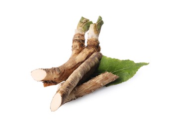 Photo of Fresh horseradish roots and leaf isolated on white