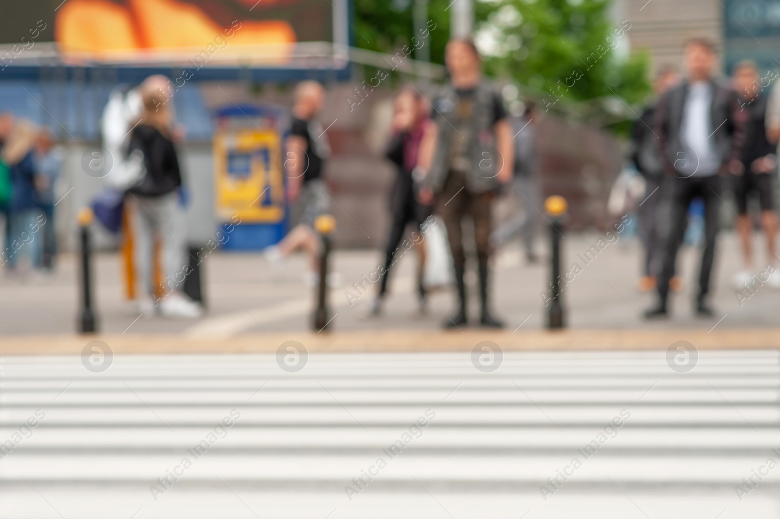 Photo of People waiting to cross street in city, blurred view