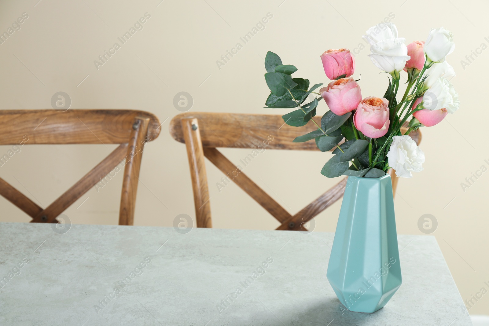 Photo of Vase with beautiful flowers as element of interior design on table in room. Space for text