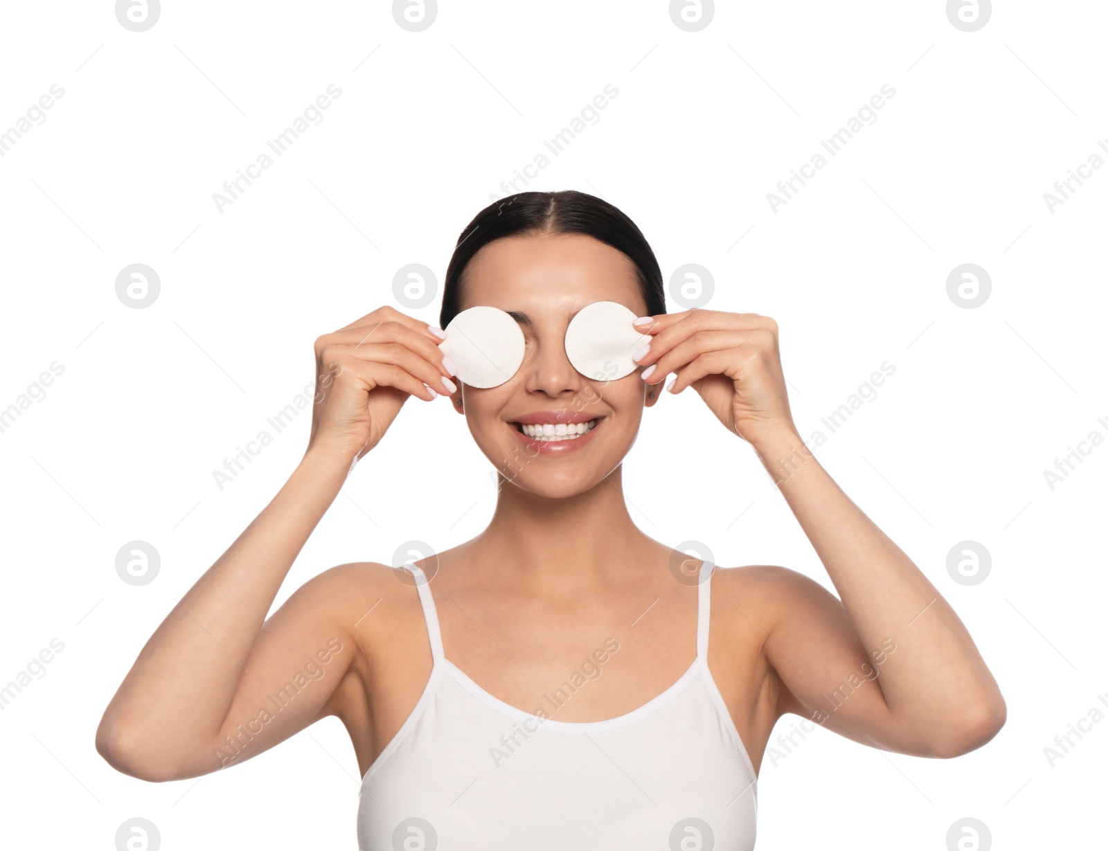 Photo of Young woman using cotton pads with micellar water on white background