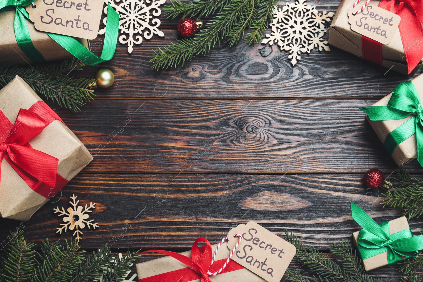 Photo of Flat lay composition with presents from secret Santa on wooden background, space for text