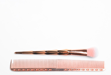 Photo of Modern hair comb and brush on white background, top view