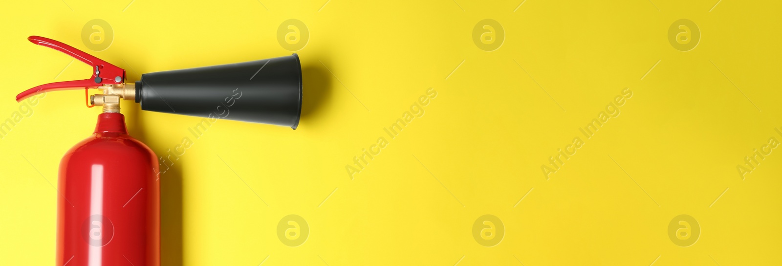 Image of Fire extinguisher on yellow background, top view with space for text. Banner design