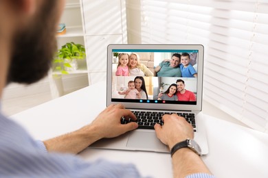 Image of Man having online meeting with family members via videocall application at home, closeup