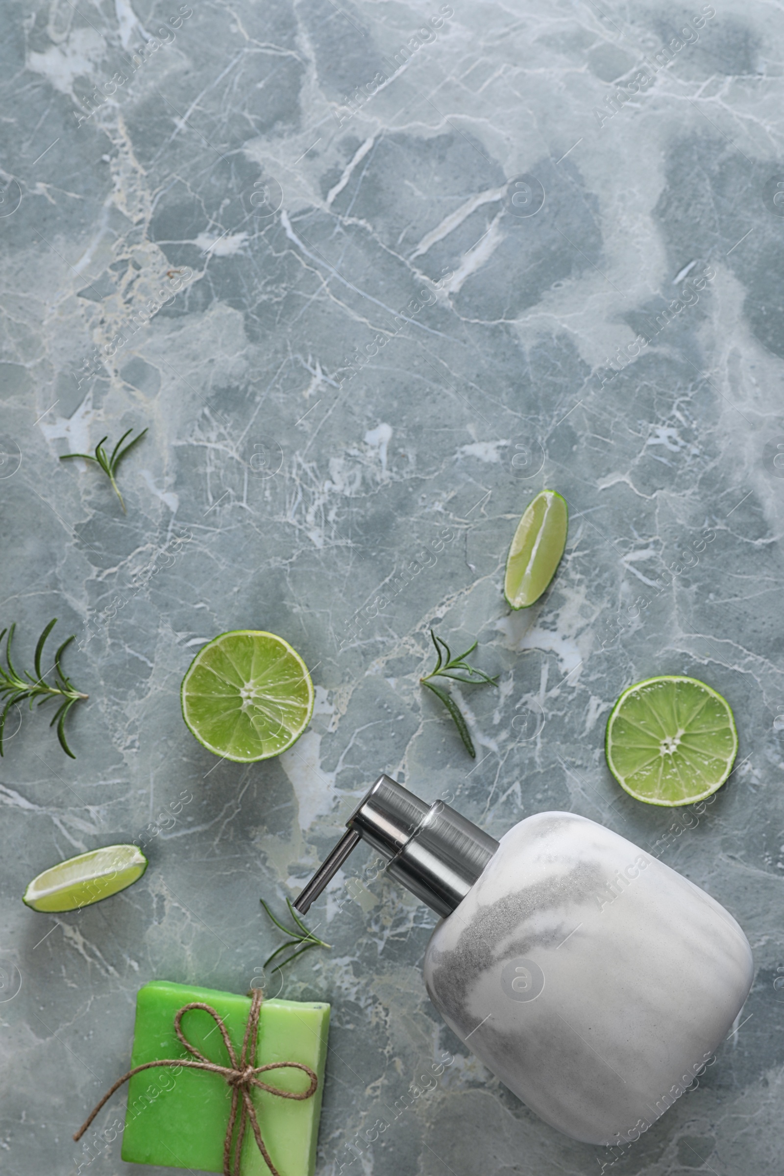 Photo of Flat lay composition with soap dispenser on grey marble background. Space for text