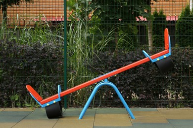 Photo of Empty colorful outdoor children's playground with seesaw