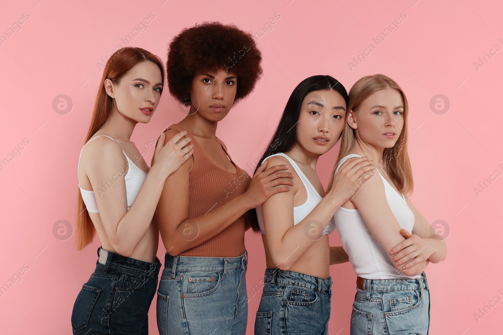 Photo of Portrait of beautiful young women on pink background