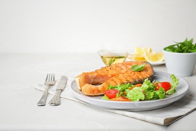 Photo of Plate with tasty salmon steak on table