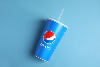 Photo of MYKOLAIV, UKRAINE - JUNE 08, 2021: Paper Pepsi cup on light blue background, top view