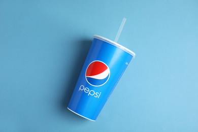 MYKOLAIV, UKRAINE - JUNE 08, 2021: Paper Pepsi cup on light blue background, top view