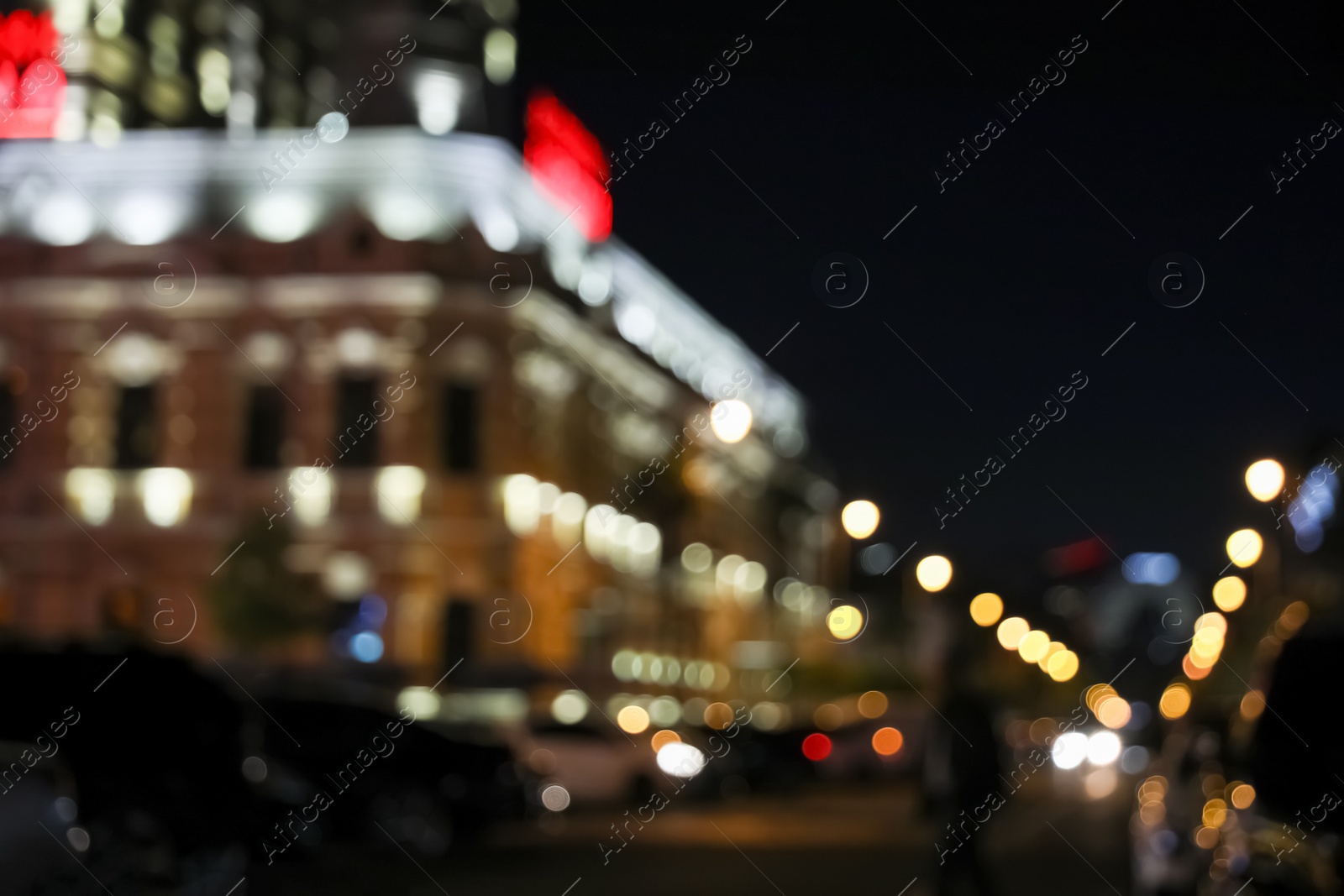 Photo of Blurred view of city street with lights at night. Bokeh effect