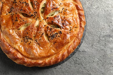 Photo of Tasty homemade pie with filling on grey table, top view