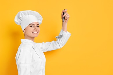 Professional chef with ladle on yellow background. Space for text
