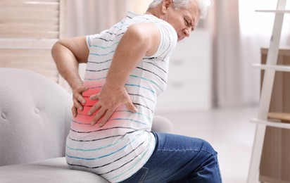 Image of Senior man suffering from pain in lower back at home