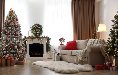 Festive living room interior with Christmas trees and fireplace