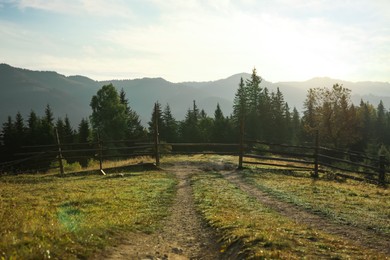 Picturesque view of mountain landscape with wooden fence in morning