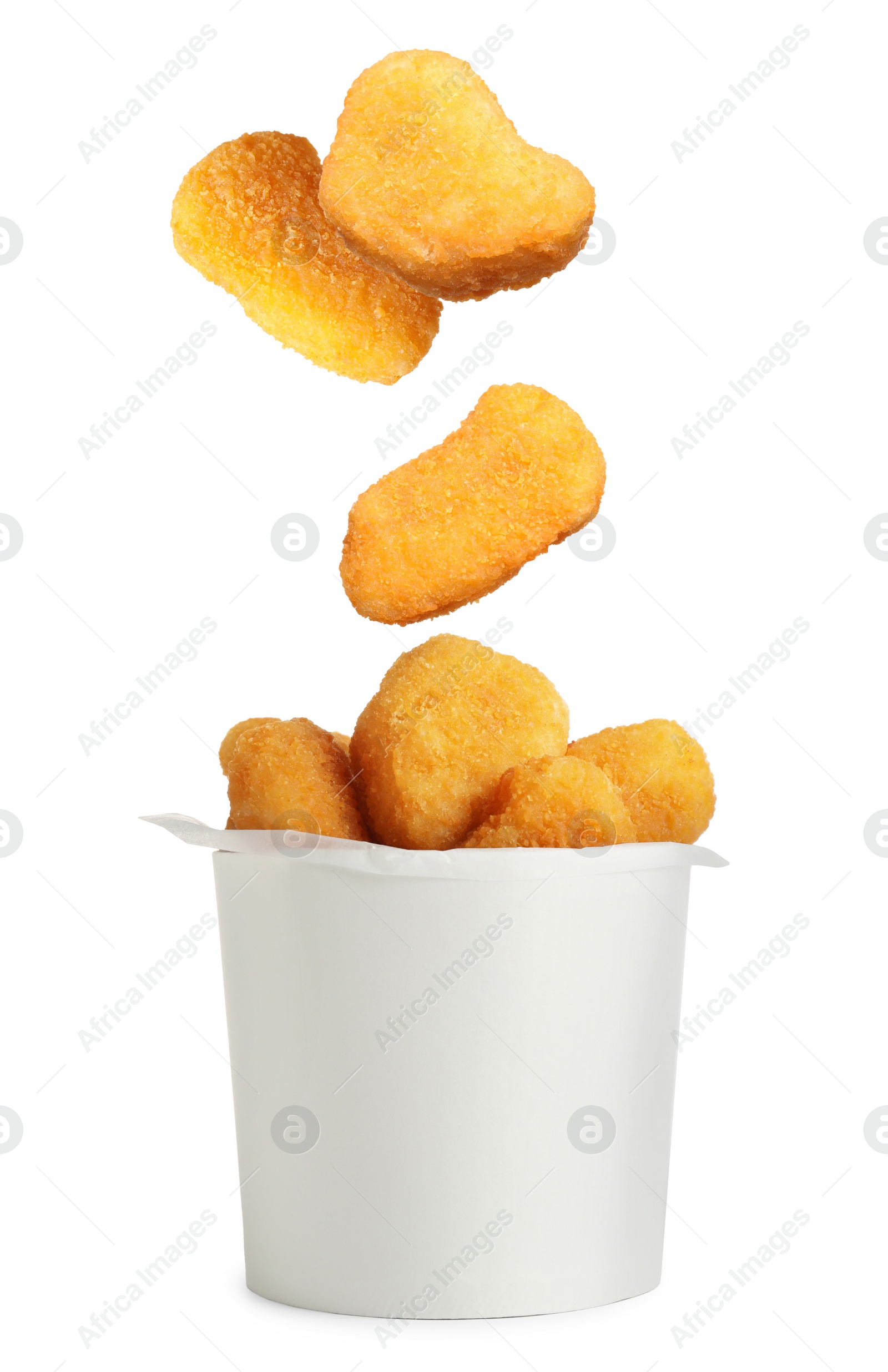 Image of Fresh chicken nuggets falling into container on white background