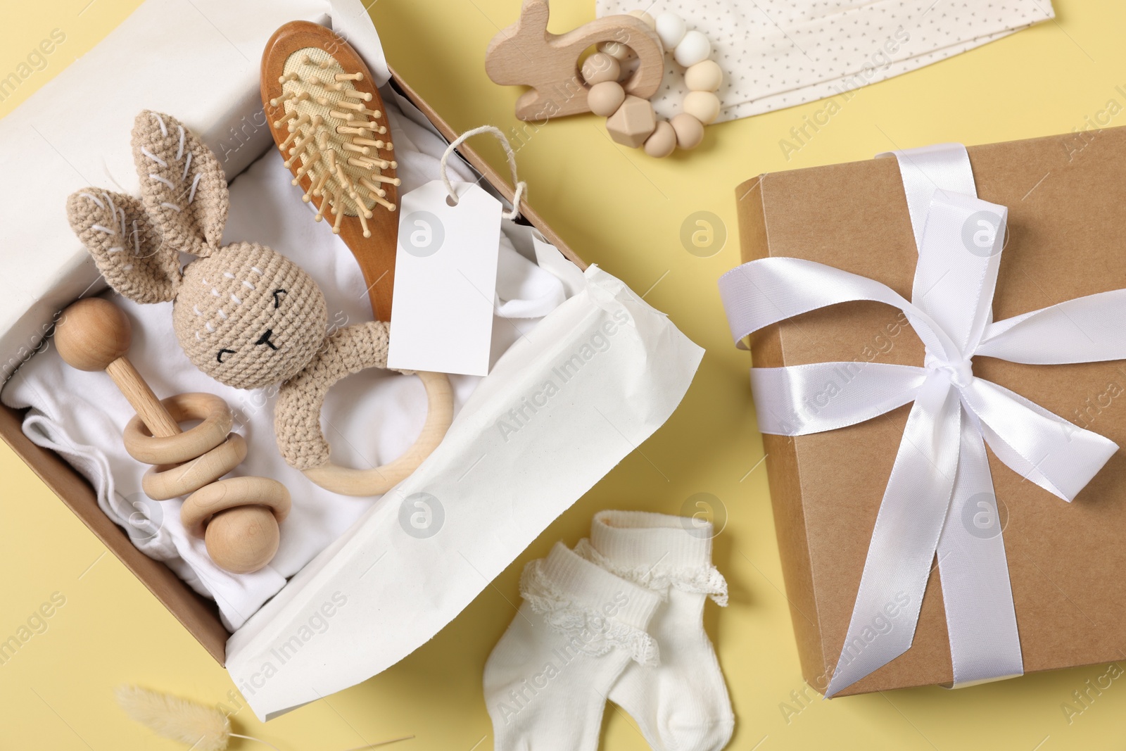 Photo of Flat lay composition with different baby accessories and blank card on yellow background