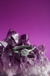 Beautiful luxury engagement ring with gemstone on amethyst, closeup