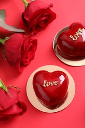 Photo of St. Valentine's Day. Delicious heart shaped cakes and roses on red background, flat lay