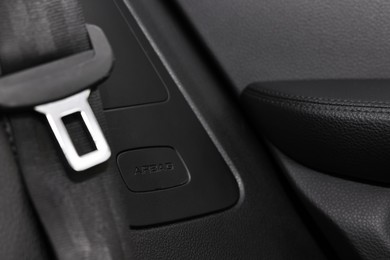 Photo of Safety belt and seat inside of modern black car, closeup