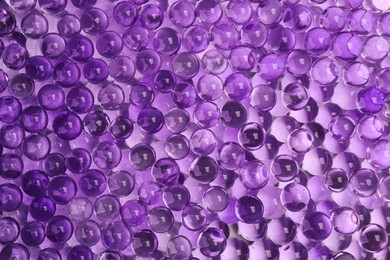 Photo of Top view of violet vase filler as background. Water beads