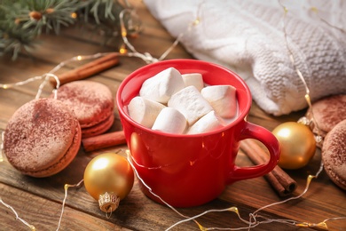 Composition with hot cocoa drink on wooden background