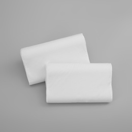 Photo of Clean soft orthopedic pillows on grey background, top view