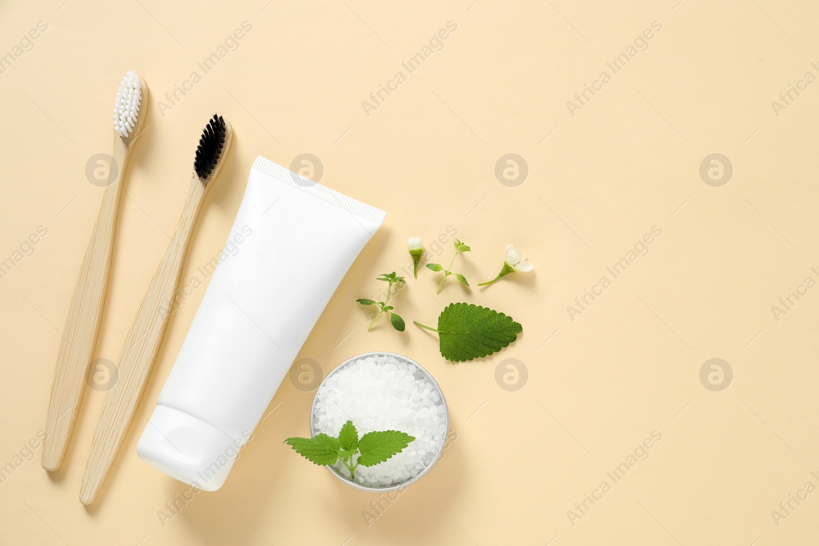 Photo of Flat lay composition with toothbrush and herbs on beige background. Space for text