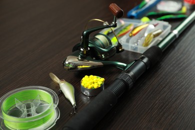 Photo of Fishing tackle on dark wooden background, closeup