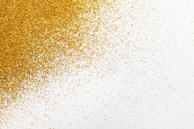 Golden glitter on white background, top view