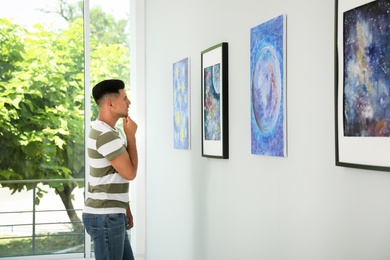Photo of Thoughtful man at exhibition in art gallery