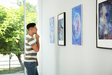 Thoughtful man at exhibition in art gallery