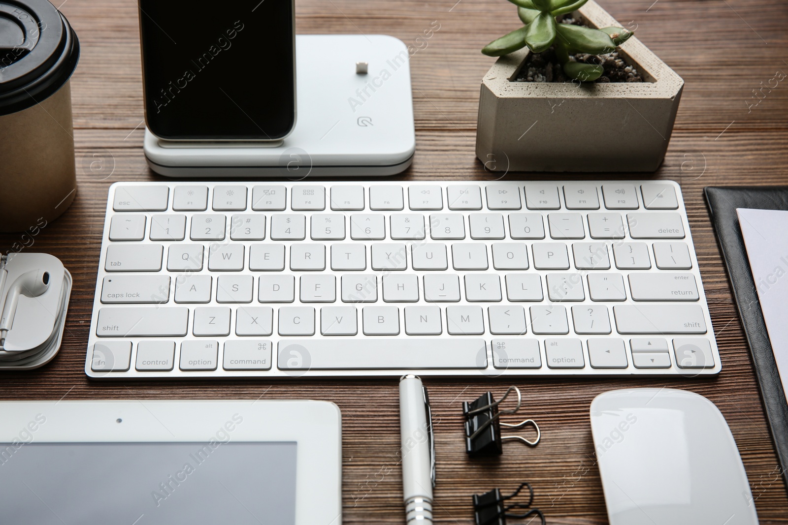 Photo of MYKOLAIV, UKRAINE - JULY 20, 2020: Composition with iPhone 11 and different Apple gadgets on wooden table