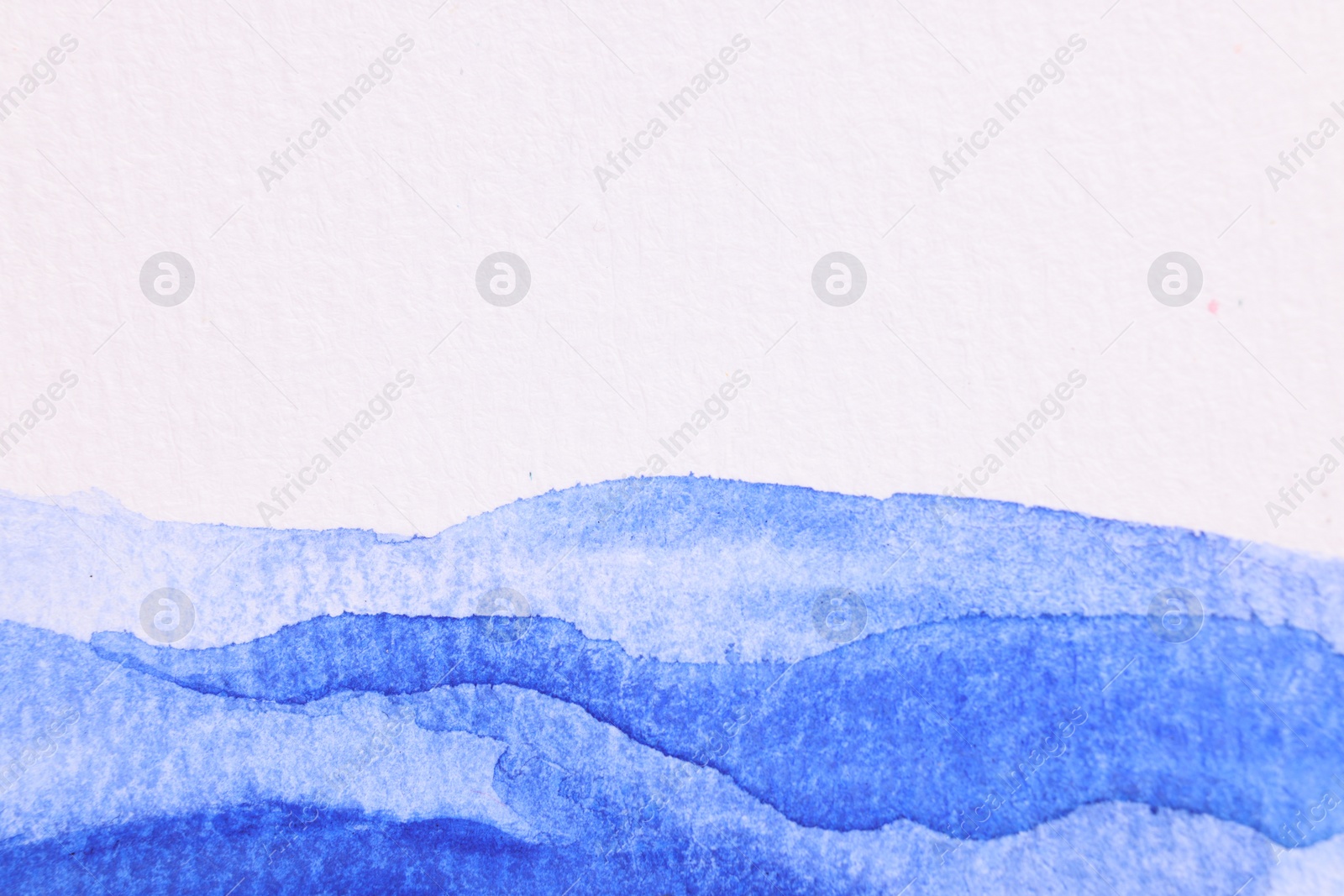 Photo of Abstract blue watercolor painting on white paper, top view. Space for text