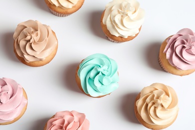 Photo of Flat lay composition with delicious birthday cupcakes on white background