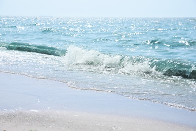 Tropical sandy beach washed by sea on sunny day