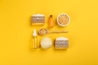 Photo of Flat lay composition with natural handmade soap on yellow background