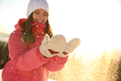 Photo of Young woman having fun outdoors on snowy winter day