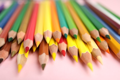 Photo of Composition with color pencils on pink background