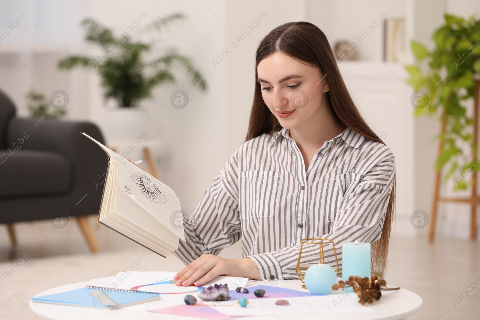 Photo of Astrologer making forecast of fate at table indoors. Fortune telling