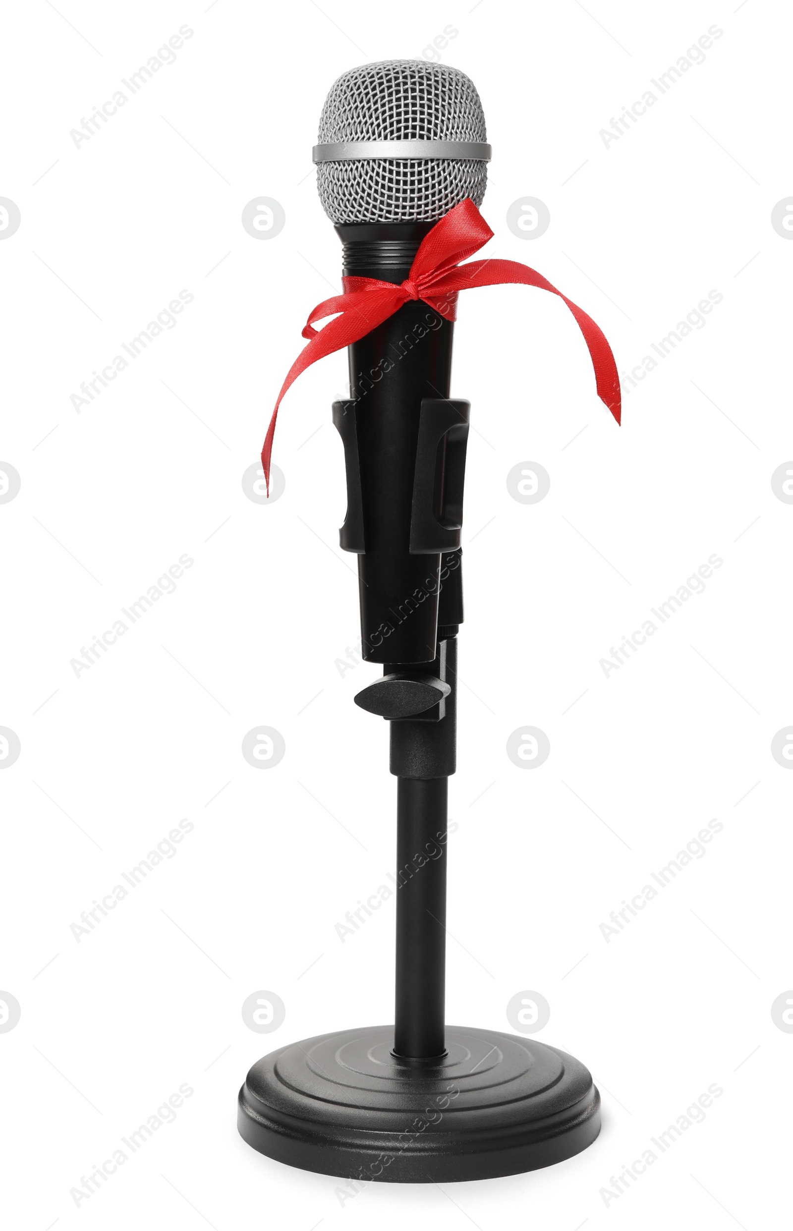 Photo of Microphone with red bow isolated on white. Christmas music
