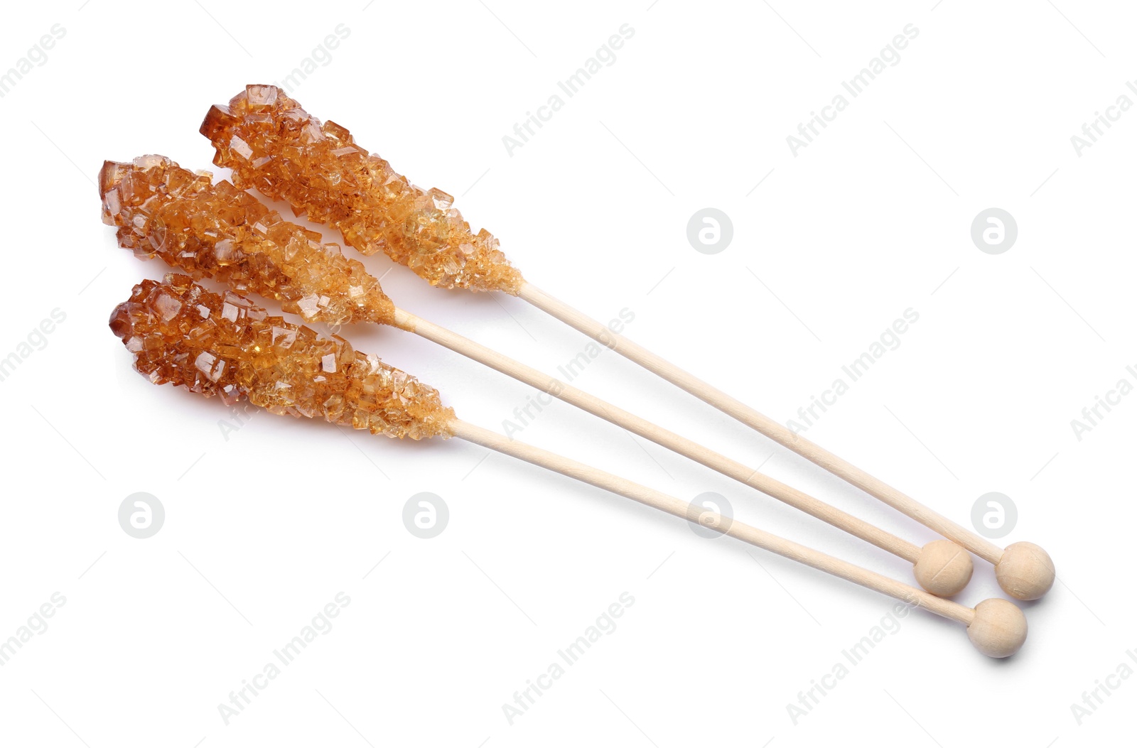 Photo of Wooden sticks with sugar crystals isolated on white, top view. Tasty rock candies