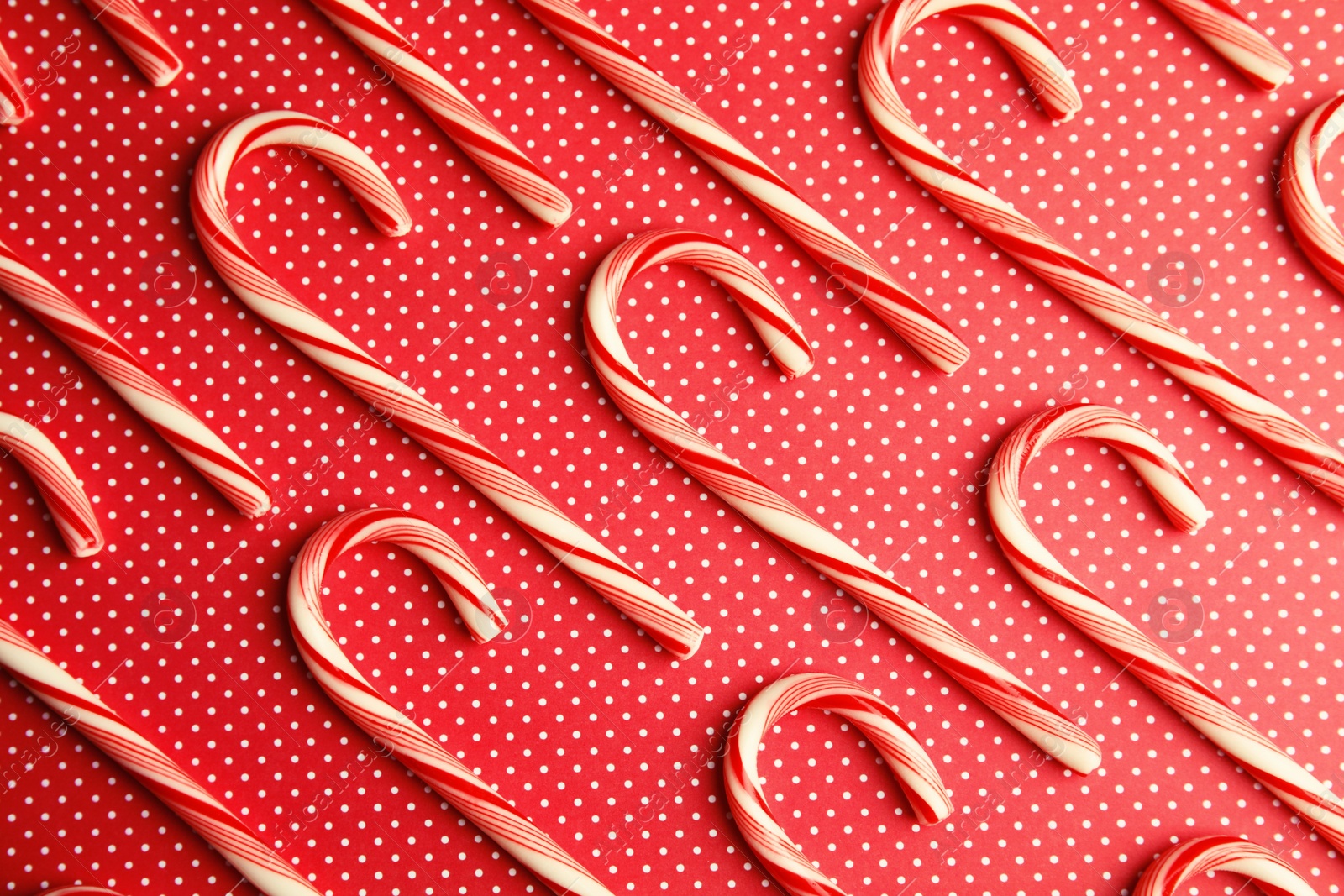 Photo of Flat lay composition with tasty candy canes on color background