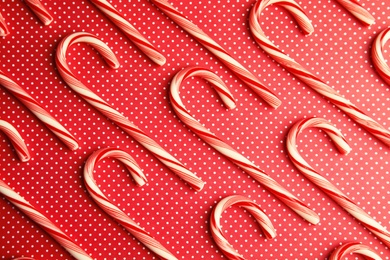 Flat lay composition with tasty candy canes on color background