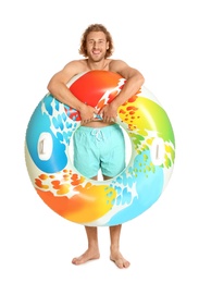 Photo of Attractive young man in swimwear with colorful inflatable ring on white background