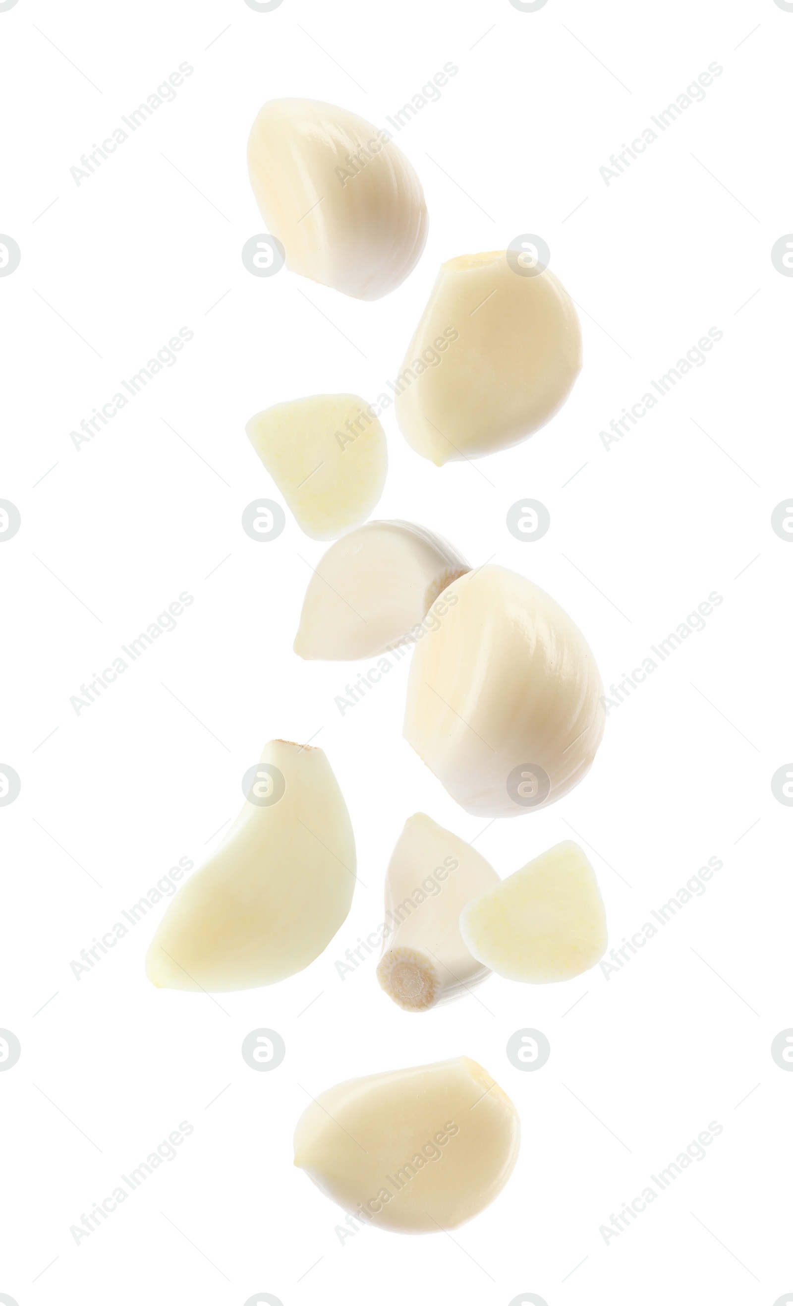 Image of Set of falling garlic cloves on white background