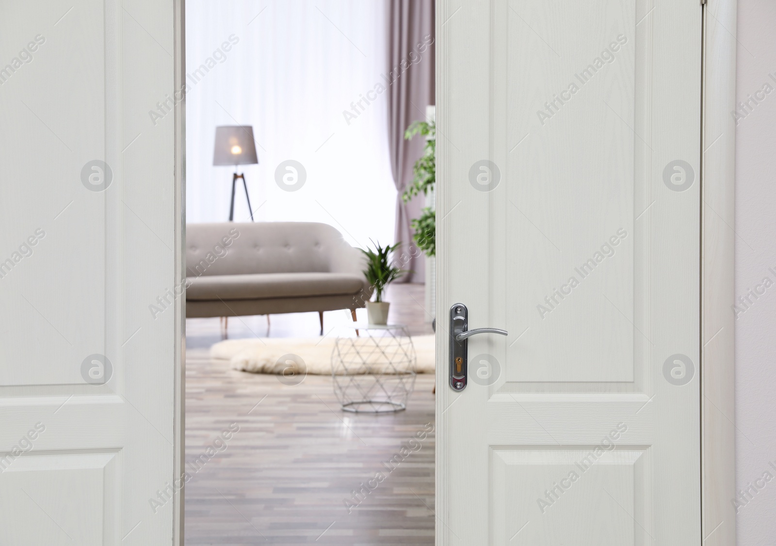 Photo of Stylish room interior, view through open door